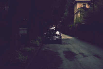 Car on street amidst buildings in city at night