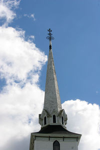 Low angle view of tower and building against sky