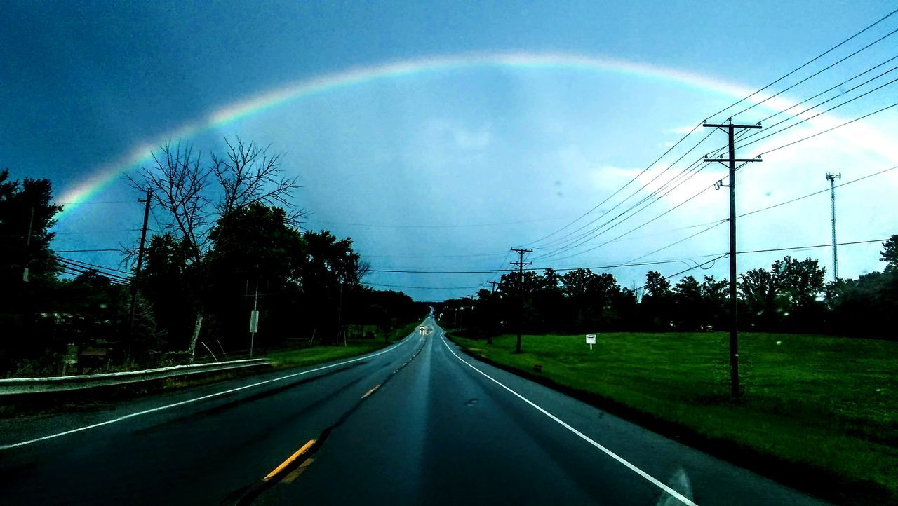 ROAD AMIDST RAINBOW AGAINST SKY