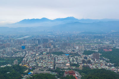 High angle view of buildings in city against sky