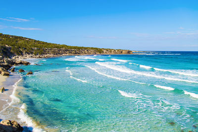 Scenic view of sea against blue sky