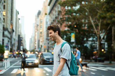 Man standing on street in city
