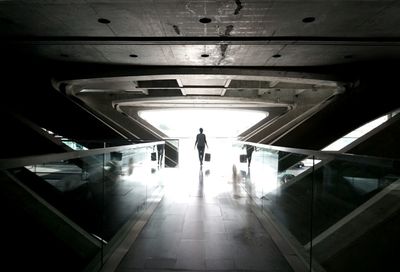 Woman standing in tunnel