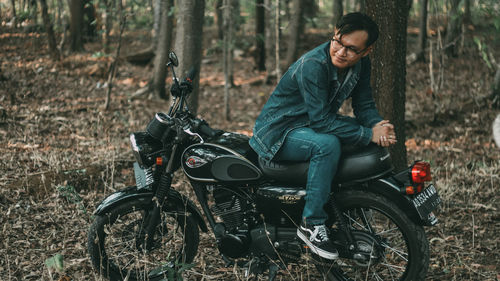 Man riding bicycle in forest