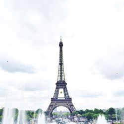 Low angle view of eiffel tower against cloudy sky