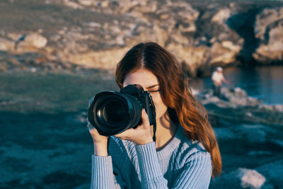 Portrait of woman photographing camera
