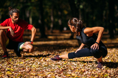 Young couple stretching after training in the park