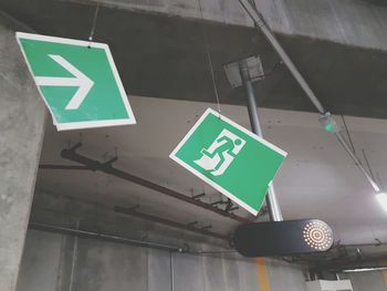 Low angle view of road sign at subway station