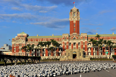 Tower of building against cloudy sky
