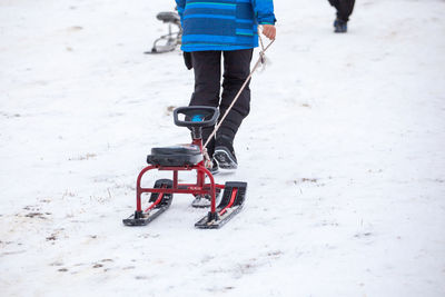 Low section of person skiing on snow