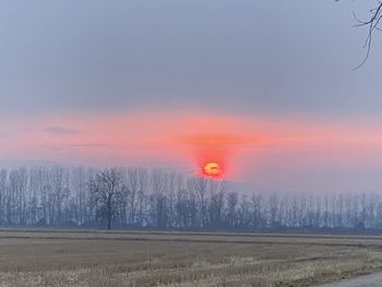 Scenic view of field against sky during sunset