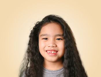 Portrait of smiling boy against white background