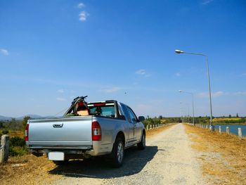 Cars on road against blue sky