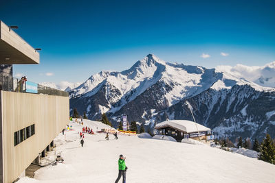 Man on snow covered mountain against sky