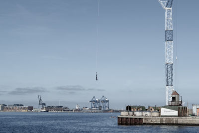 Commercial dock by sea against sky