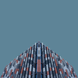 Low angle view of modern building against clear blue sky