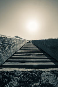 Surface level of footpath against clear sky