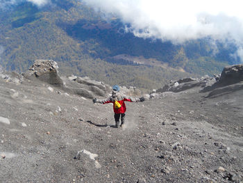 Rear view of man standing on mountain