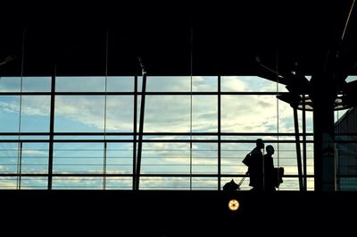 Silhouette people in city at night