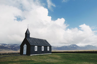 Built structure on field against sky