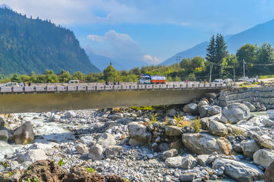 Scenic view of river and mountains against sky