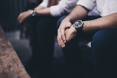 Midsection of business colleagues sitting in office