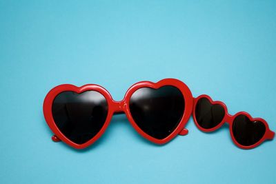 Close-up of sunglasses against blue background