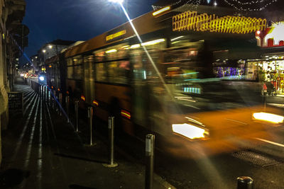 Train at railroad station platform at night