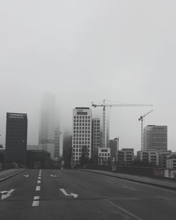 City street against clear sky in foggy weather