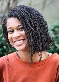 Portrait of smiling young woman with dreadlocks