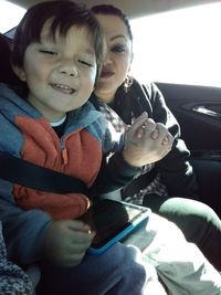 Portrait of smiling boy sitting in car