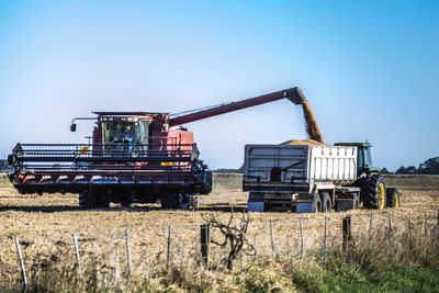 View of rusty machinery on field against clear sky