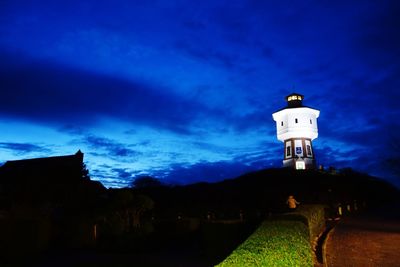 Low angle view of lighthouse against cloudy sky