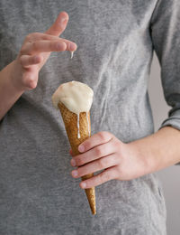 Midsection of person holding ice cream