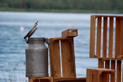 Canister on wooden crates at lakeshore