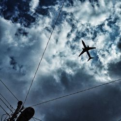 Low angle view of airplane flying in sky