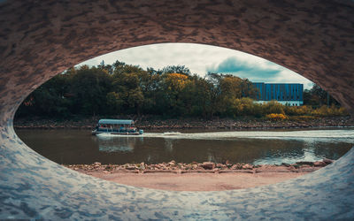 Reflection of trees in water against sky