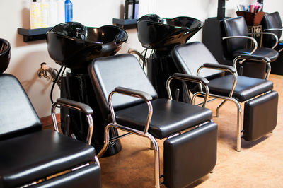 Chairs by sink bowl at hair salon