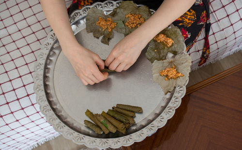 High angle view of woman preparing food on table