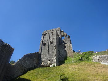 Low angle view of fort against clear blue sky