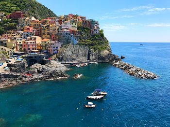 Scenic view of sea and buildings against sky