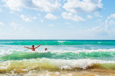 Boy and his mum playing in sea, alvor, algarve, portugal, europe