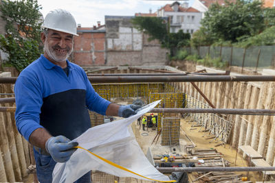 Foreman officer inspector at construction site checking and inspecting progressing work 