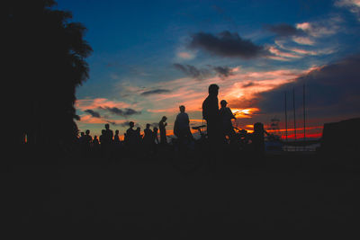 Silhouette people against sky during sunset