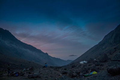 Scenic view of mountains against blue sky at night