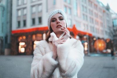 Portrait of woman looking at city in winter