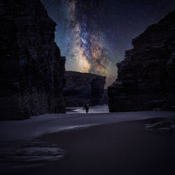 Man on road against sky at night