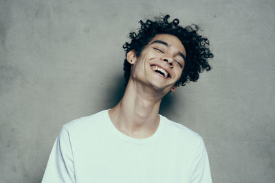 Portrait of smiling man against wall