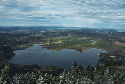 High angle view of city by sea against sky