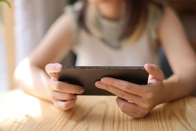 Midsection of woman using mobile phone